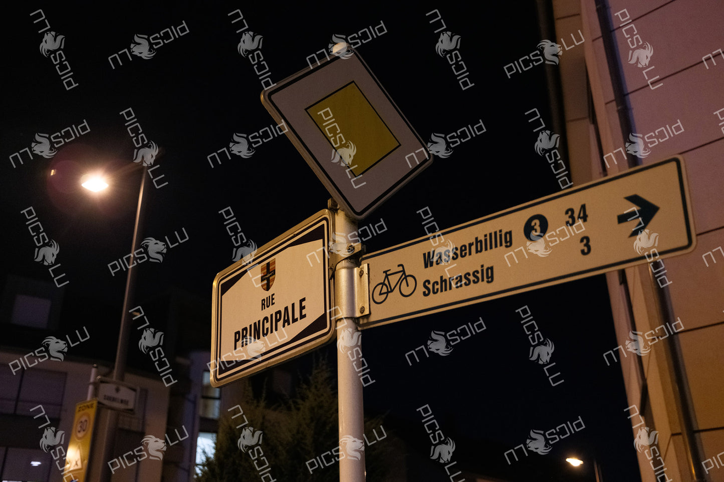 Street signs at night in Rue Principale, Luxembourg