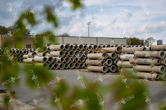 Stacked concrete pipes in Contern industrial yard