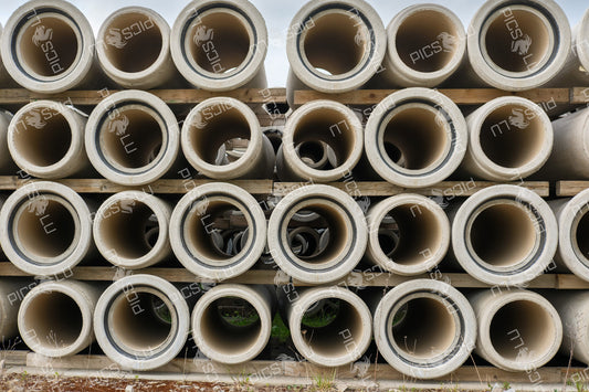 Industrial concrete pipes stacked for construction use in Sandweiler