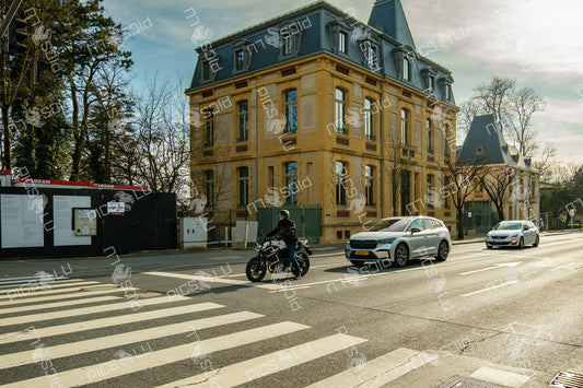 Motorcycle and cars at a crosswalk in Luxembourg city