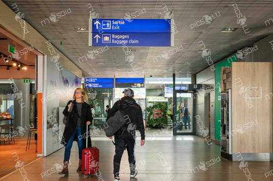 Directional signs to exit and baggage claim at Luxembourg Airport