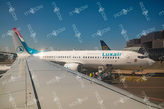 Luxair aircraft at gate viewed from airplane window at Luxembourg Airport