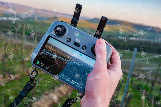 Flying drone over Remich vineyards during golden hour