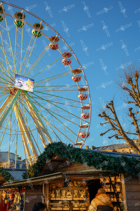 Ferris wheel cabins against a blue sky