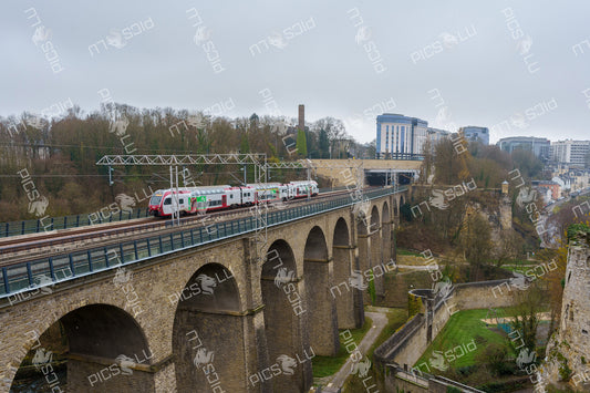 Train crossing the historic viaduct in Luxembourg City