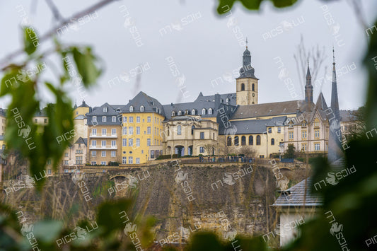 View of Luxembourg City’s upper old town and cliffs thru trees