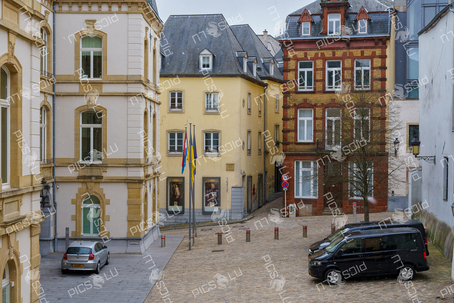 Small square with historic buildings and flags in Luxembourg City
