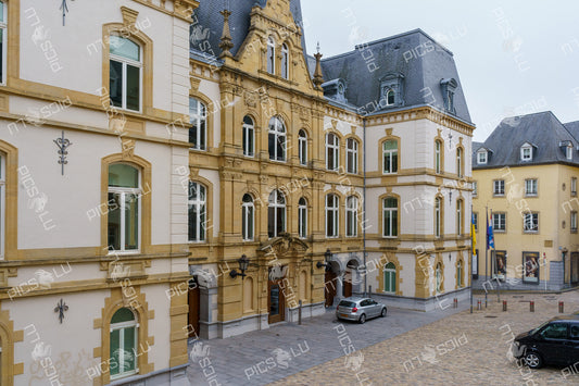 Small square with historic buildings and flags in Luxembourg City