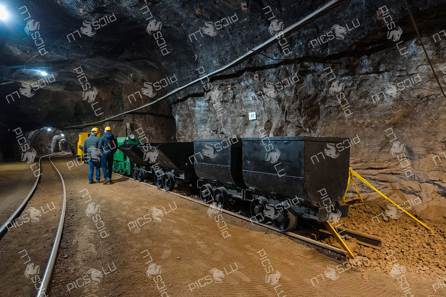 Historic mining train and ore carts inside underground tunnel
