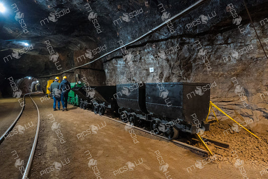 Historic mining train and ore carts inside underground tunnel