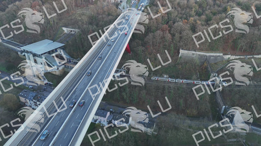 Aerial view of Grand Duchess Charlotte Bridge with traffic and train, Kirchberg Plateau skyline, Luxembourg City
